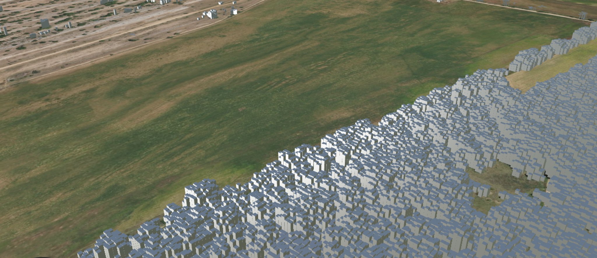 The same aerial view with the canopy layer on: every tree replaced by an extruded block whose height is its measured LiDAR canopy height, so the forest edge becomes a wall of grey volumes against the bare field.